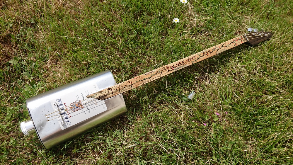 Cordophone fabriquée à partir d'une boîte métallique.